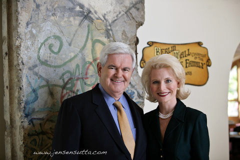 Candidate for President Newt Gingrich in front of a piece of the Berlin Wall